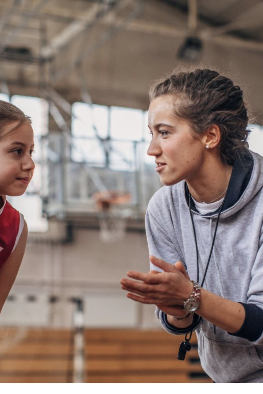 Coach talking with young athlete